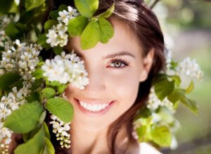 spring beauty makeover - beautiful happy brunette woman in the park on a warm summer day